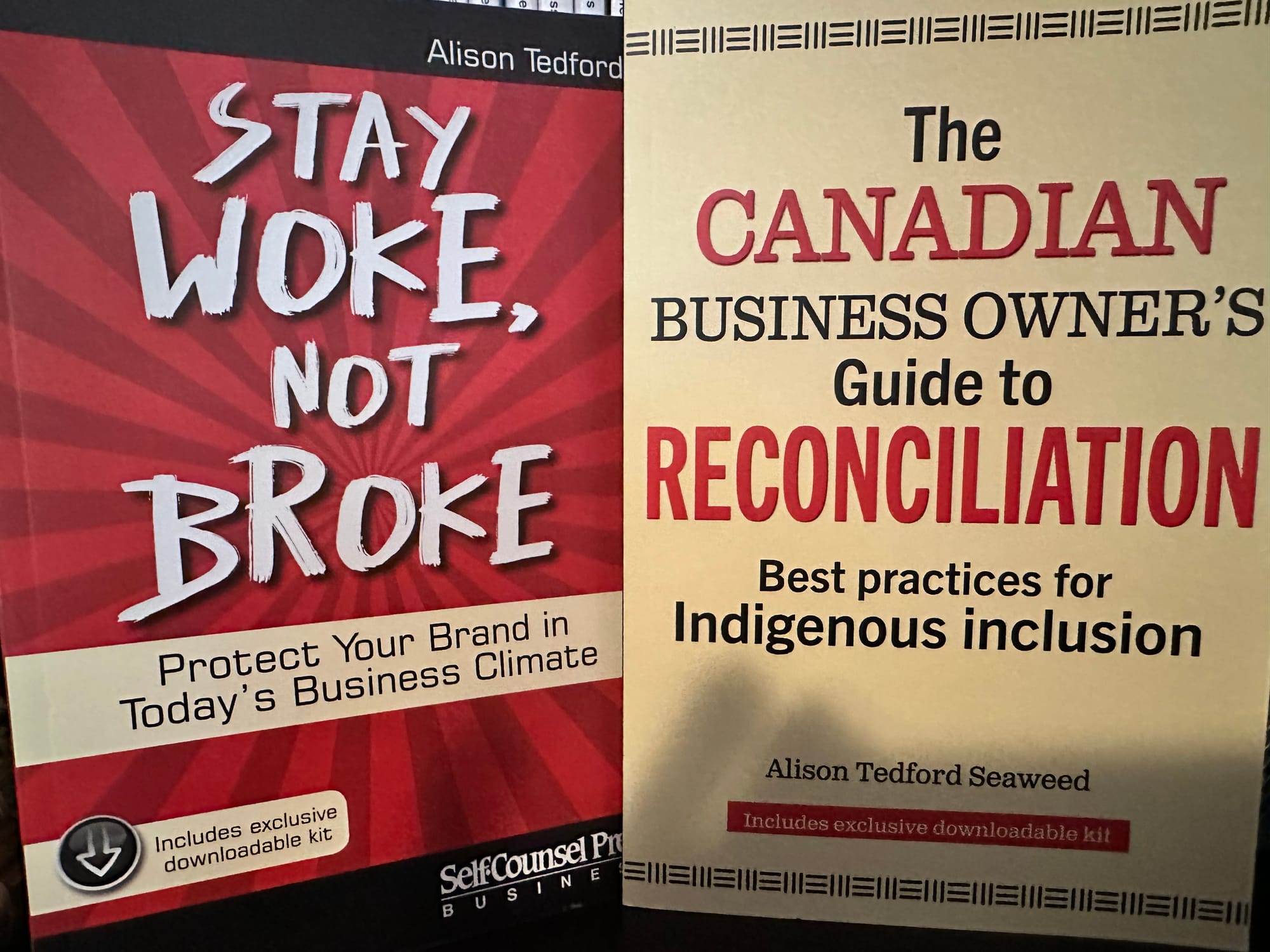 Photo of two books, Stay Woke, Not Broke and The Canadian Business Owner's Guide to Reconciliation